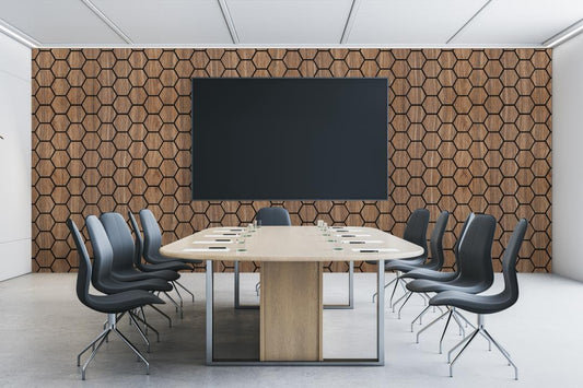 Modern conference room featuring hexagon wood wall panels and a contemporary meeting table
