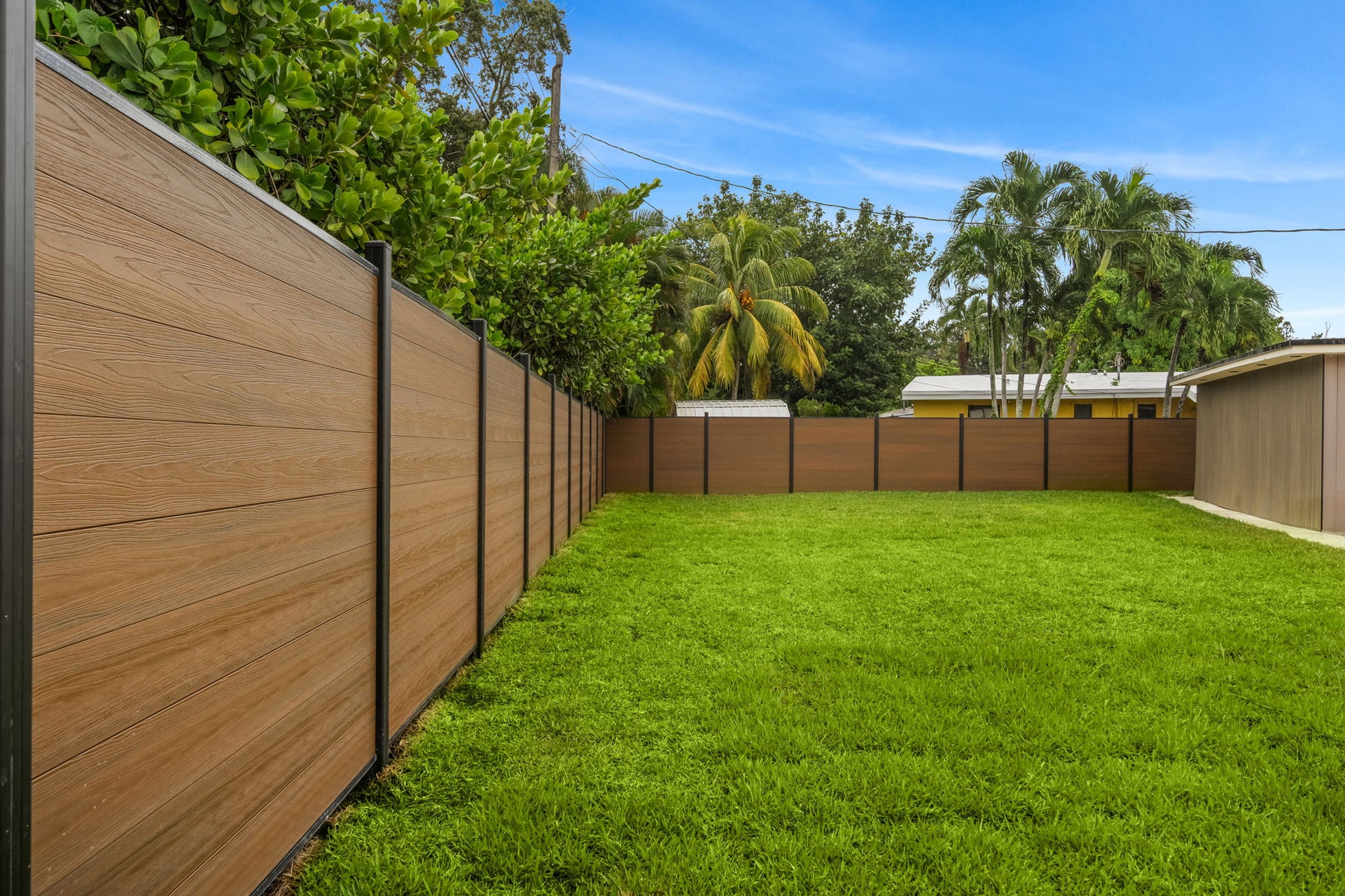 Modern walnut co extruded composite privacy fence
