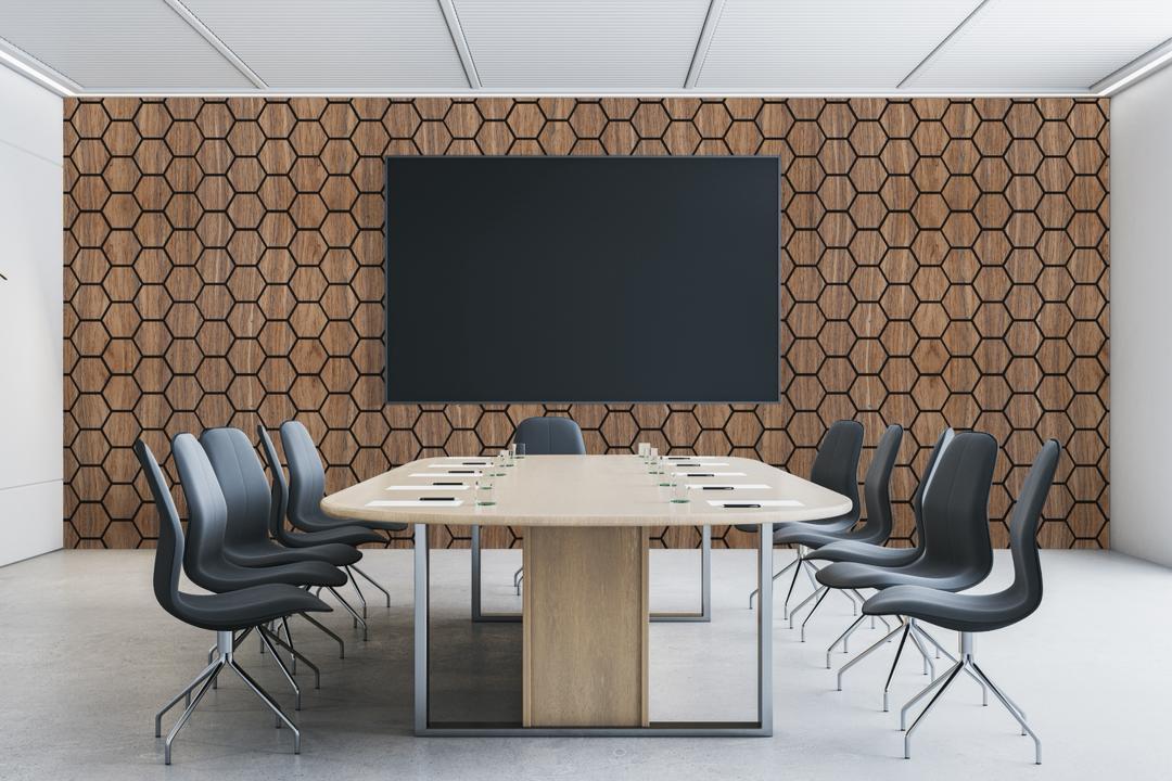 Modern conference room featuring hexagon wood wall panels and a contemporary meeting table