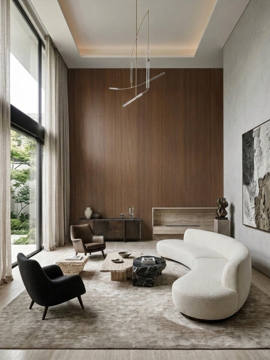Tall walnut wood veneer panel accent wall in a modern living room with curved white sofa