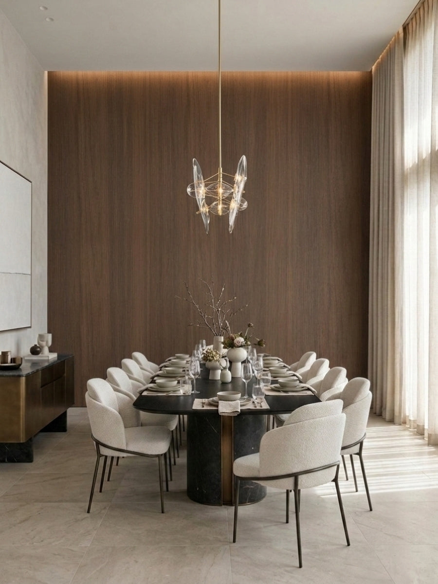 Walnut wood veneer panel dining room wall with warm backlighting and a long formal table