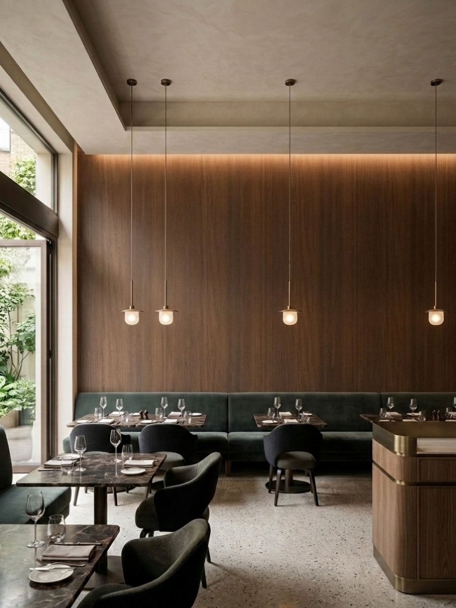 Walnut wood veneer panel wall with vertical grain and pendant lights in a contemporary restaurant
