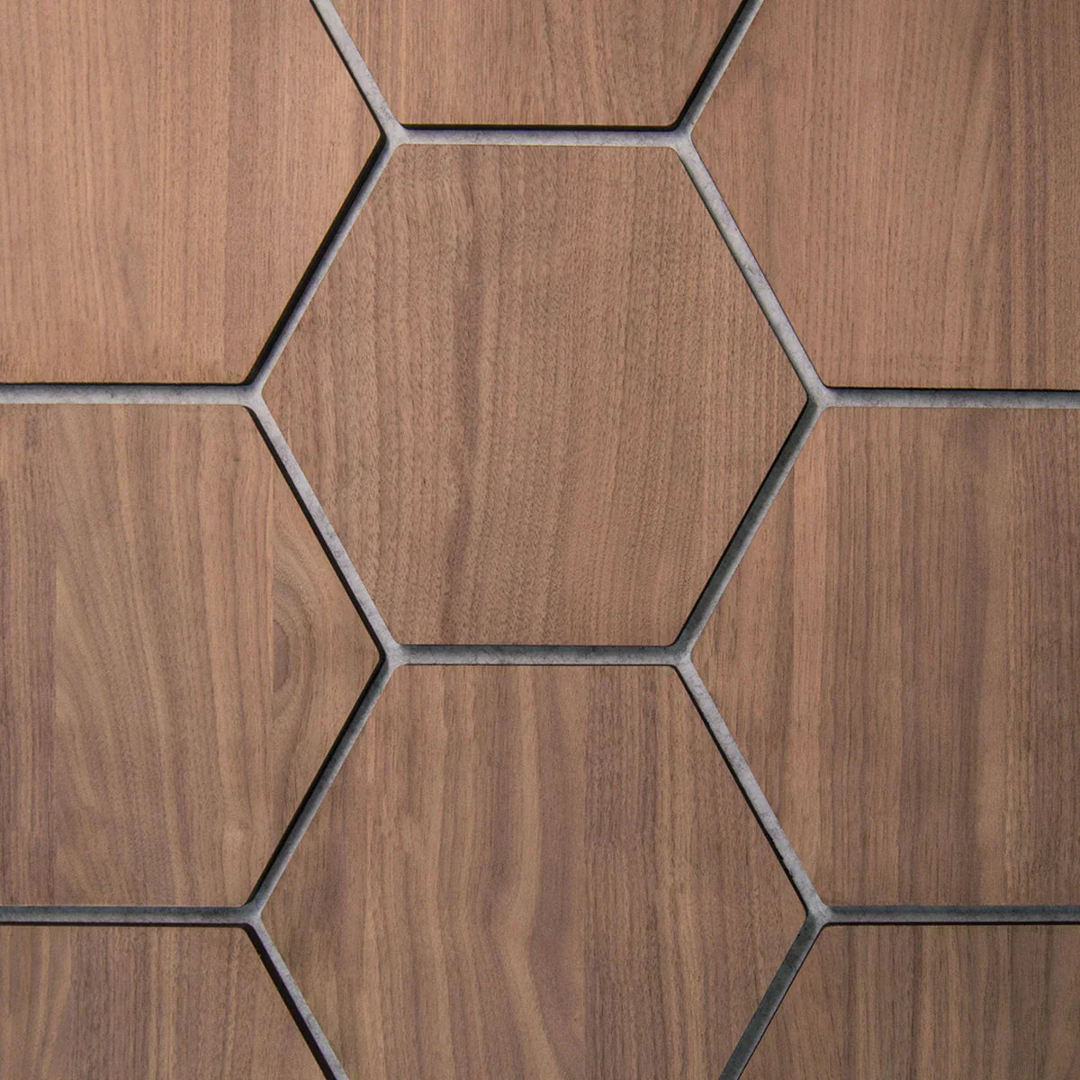 Close-up of hexagon wood wall panels showing natural wood grain and geometric honeycomb pattern
